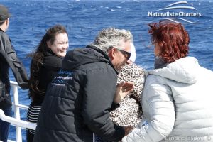 Tourists having fun while whale watching